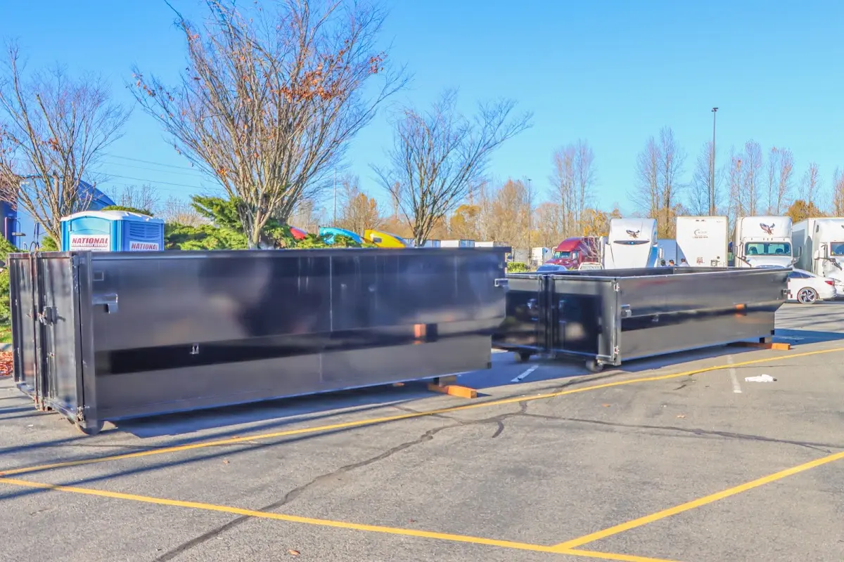 Professional dumpster rental service with roll-off container on residential driveway in Galax
